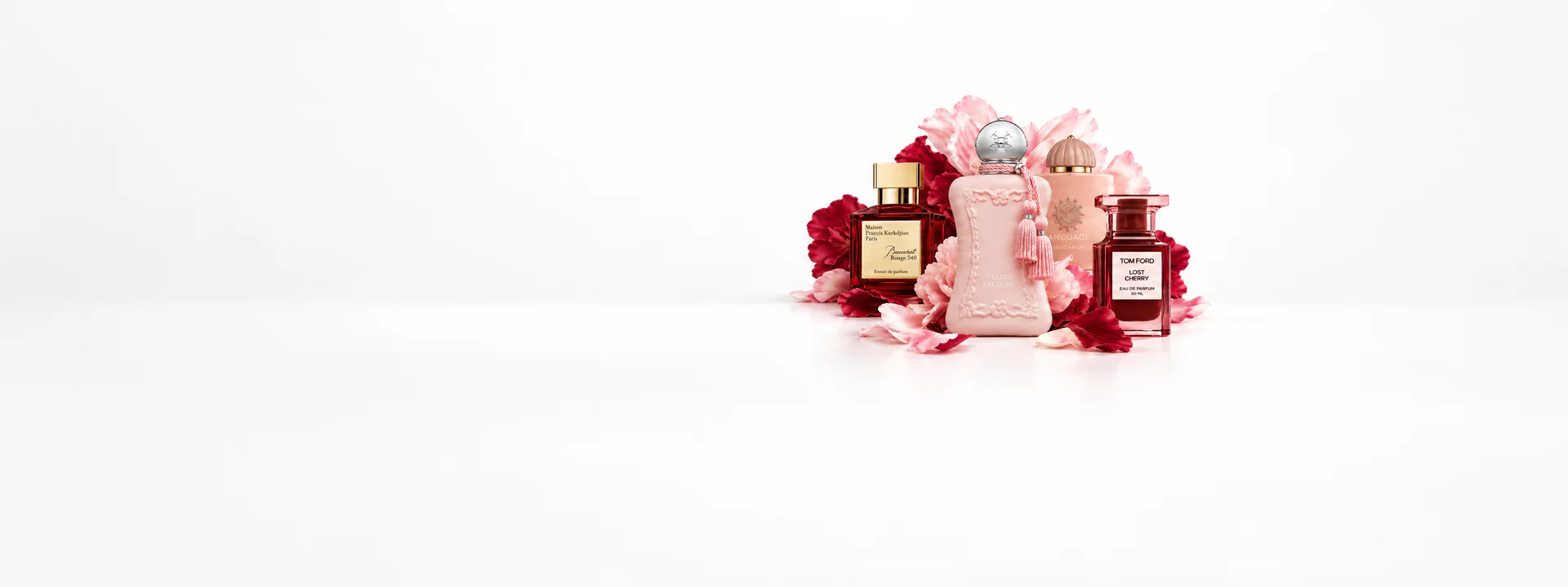 Baccarat Rouge 540, Parfums de Marly Delina, Amouage and Tom Ford Lost Cherry bottles among pink peonies